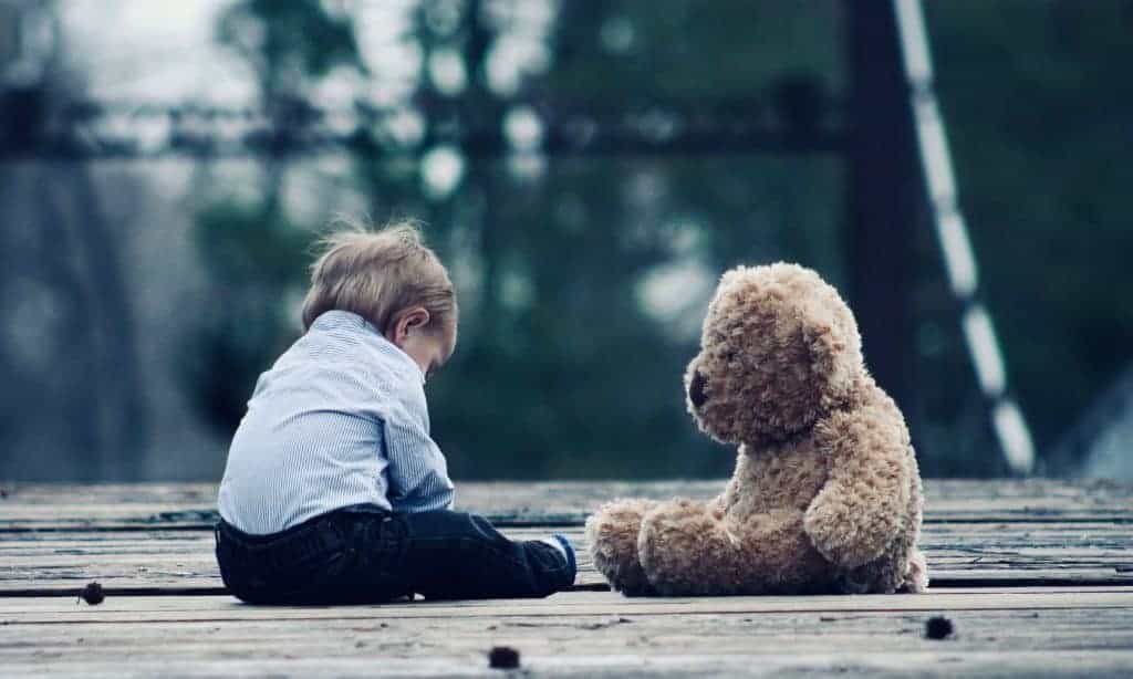 Baby sitting with teddy bear