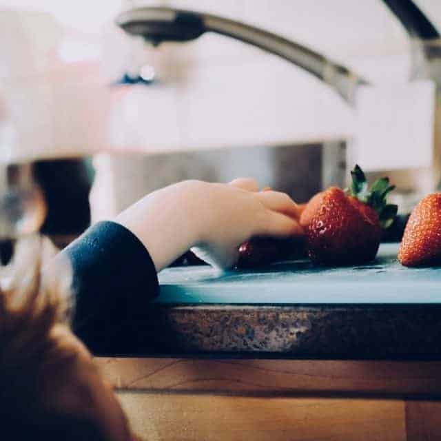 Vegan kid grabbing strawberries