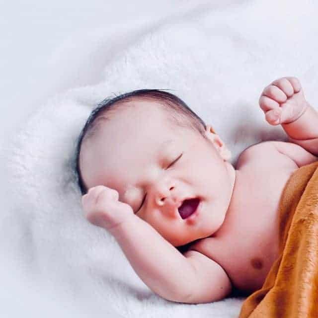 Vegan baby lying on blanket